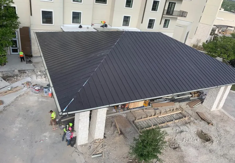 Metal roofing installation team working on a commercial building in Lower Paxton
